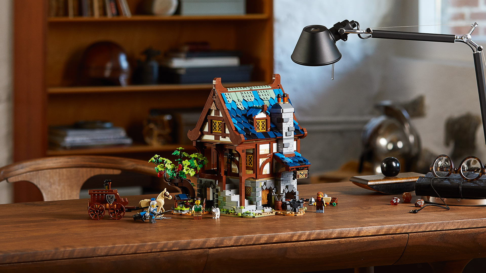 LEGO 21325 - LEGO Ideas Medieval Blacksmith  LEGO Ideas has taken a leaf out of the history books with the design of its latest set, a charming Medieval Blacksmith’s house. The new set is based on an original design by an avid LEGO builder, which achieved over 10,000 votes from LEGO fans worldwide – giving it the green light to go into production.   •Age – 18+ •Model measures: oHeight: 27cm/10.5in. oWidth: 27cm/10.5in. oDepth: 21cm/8in. •2,164 pieces •Magnificently detailed and architecturally accurate medieval blacksmith’s building and garden for display. •Includes a glowing blacksmith forge and a horse figure pulling a buildable cart Four Minifigures, including two new-for-March-2021 Black Falcon Knights. • Easily accessible, three-level building with a bedroom, kitchen and workshop packed with accessory elements such as tools, coal and armour.