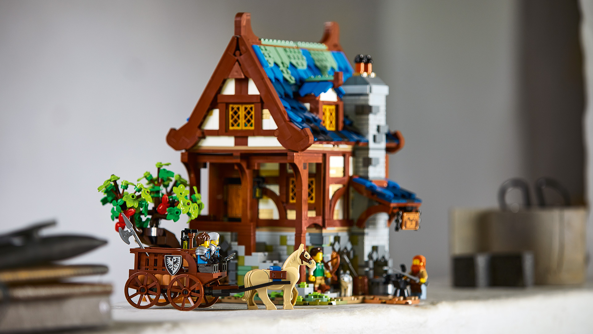 LEGO 21325 - LEGO Ideas Medieval Blacksmith  LEGO Ideas has taken a leaf out of the history books with the design of its latest set, a charming Medieval Blacksmith’s house. The new set is based on an original design by an avid LEGO builder, which achieved over 10,000 votes from LEGO fans worldwide – giving it the green light to go into production.   •Age – 18+ •Model measures: oHeight: 27cm/10.5in. oWidth: 27cm/10.5in. oDepth: 21cm/8in. •2,164 pieces •Magnificently detailed and architecturally accurate medieval blacksmith’s building and garden for display. •Includes a glowing blacksmith forge and a horse figure pulling a buildable cart Four Minifigures, including two new-for-March-2021 Black Falcon Knights. • Easily accessible, three-level building with a bedroom, kitchen and workshop packed with accessory elements such as tools, coal and armour.